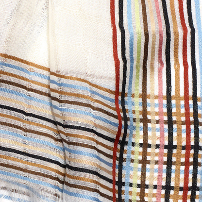 The scarfs weave is seen in detail, depicting various coloured bands that intersect perpendicular. There are brown, caramel, blue, red, green, pink, and black bands.