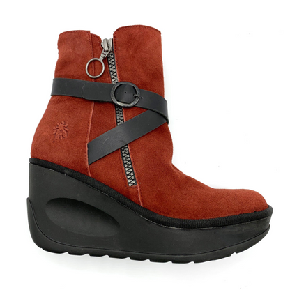 A right side view of a soft, red leather boot with a wedged black rubber sole, a silver zipper up the side, and crossing black leather straps around the front.