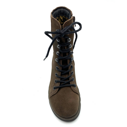 A top view of a brown suede boot with dark stitching, dark laces, and silver details.