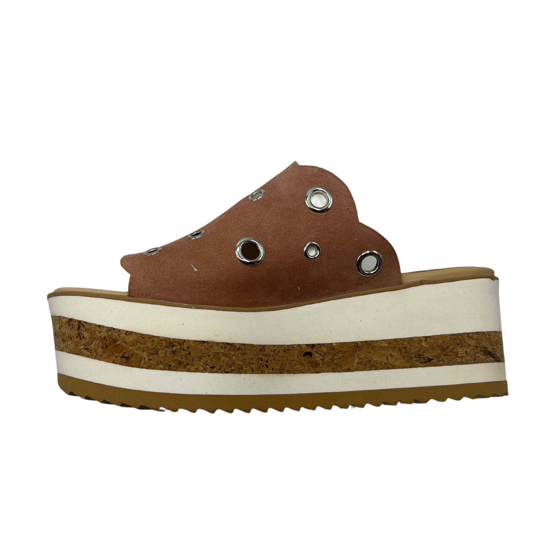 A left view of a brown suede platform slide with circular cutouts.