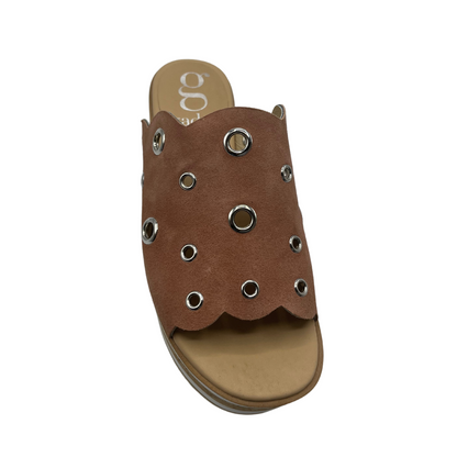 A top view of a brown suede platform slide with circular cutouts.