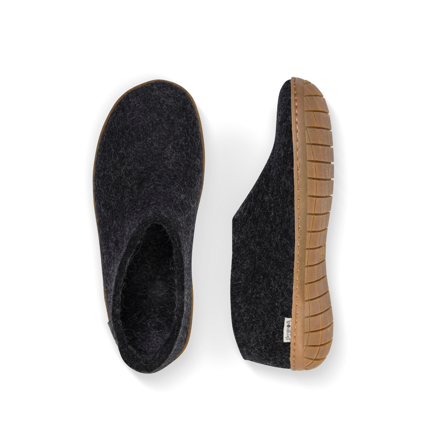An overhead view of two dark grey felted wool tall-back slippers. One is pictured straight on, showing the top face of the slipper, while the other lays on its side, showing the profile with caramel rubber sole with a row of stitching.