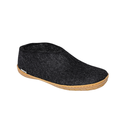 A felted dark grey tall-back slipper pictured at a slight angle, showing part of the top front and side of the slipper. A caramel rubber sole lines the bottom of the shoe with a row of stitching.