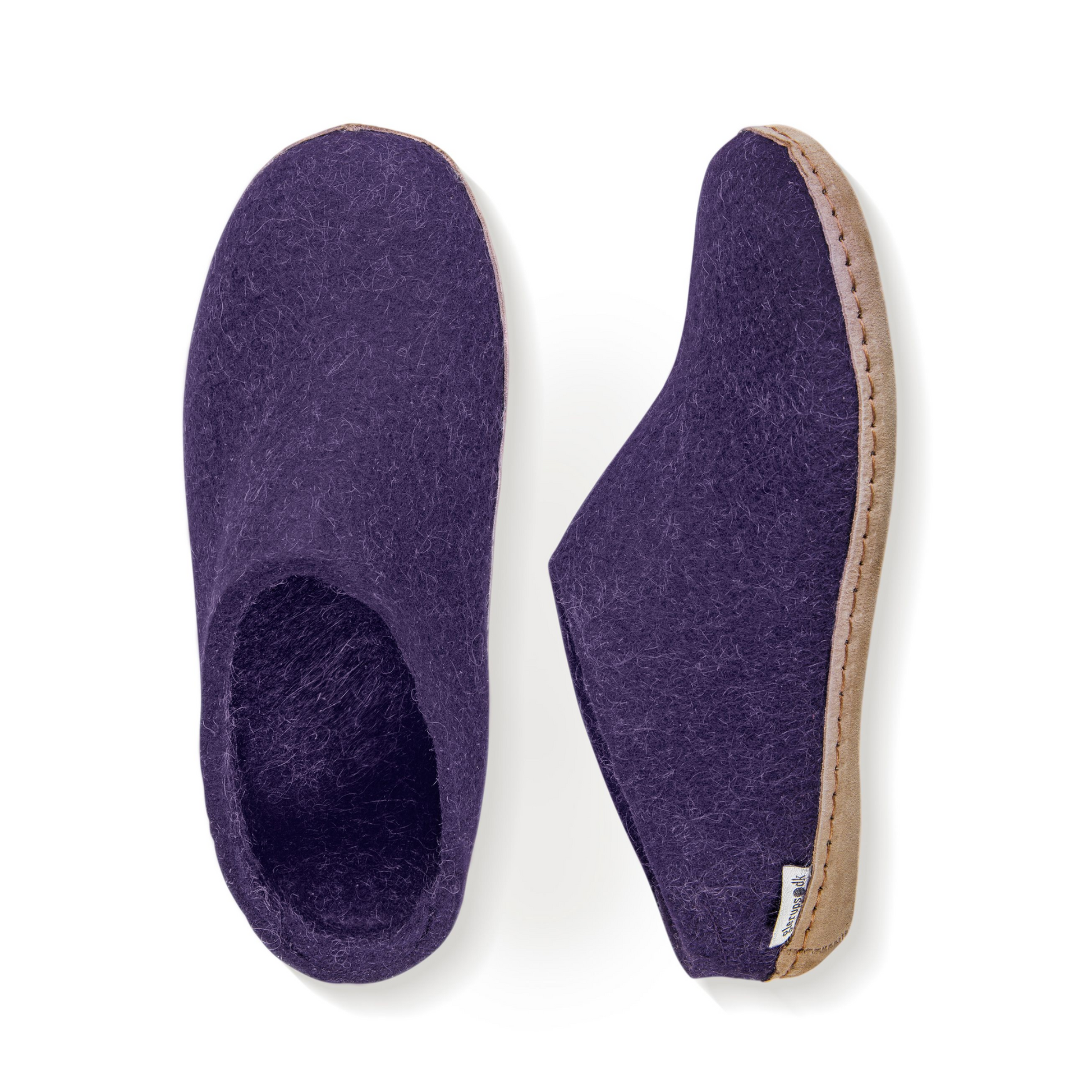 A pair of purple felted slippers is pictured from above. The heel has a low back while the sole is covered in tan leather.