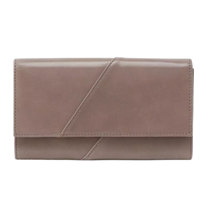 A warm grey wallet is pictured with diagonal stitch detail along foldover front.