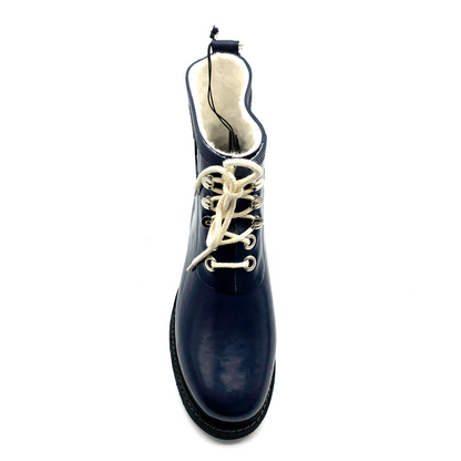 A front view of a navy rain boot with black and white details.