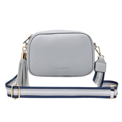 A grey small rectangular bag with tassle is pictured showing the front face. It has a blue, grey, and white shoulder strap.