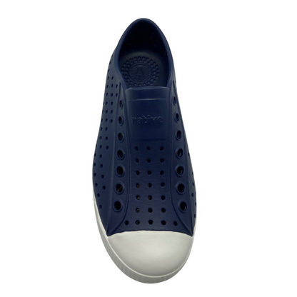 The dark navy sneaker is pictured from above showing the relief text on the tongue which says "native" with larger perforations running adjacent down to the toe around it. The white toe box and a bit of the sole is visible.