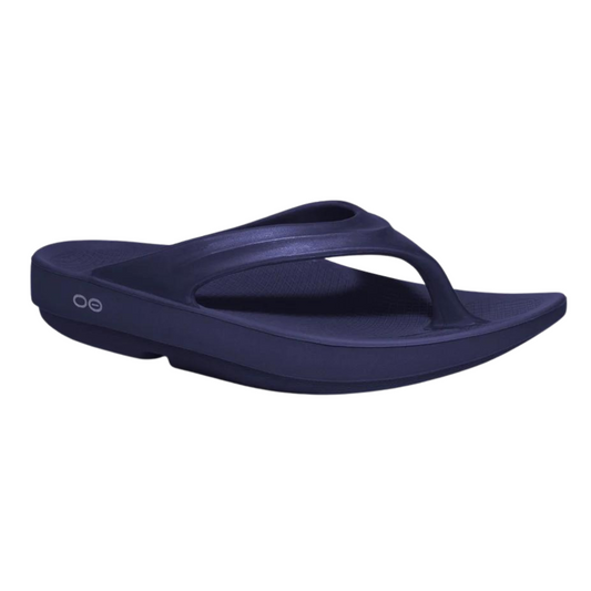 A right angle view of a navy foam sandal with a single between-toe strap and grippy sole.