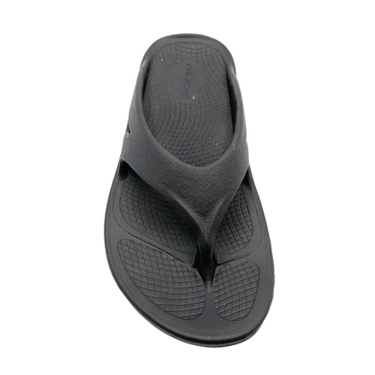 A top view of a black foam sandal with a between-toe strap.