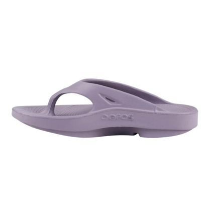 A left angle view of a light purple foam sandal with a between-toe strap.