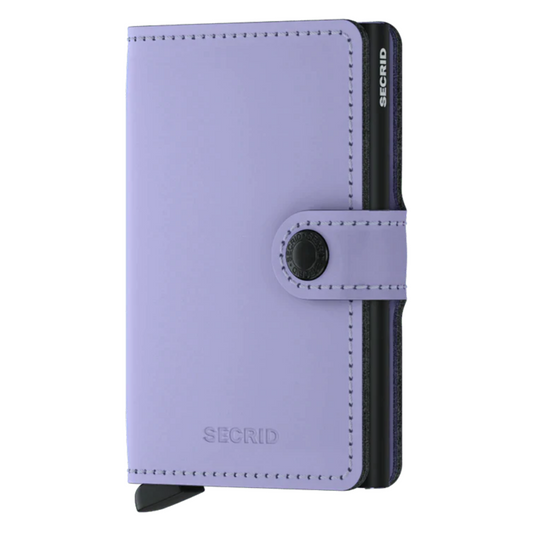 A lilac wallet is pictured with black metallic inner cardholder and a button closure.