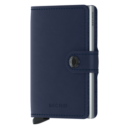 A navy wallet is pictured with silver metallic inner cardholder and a button closure.