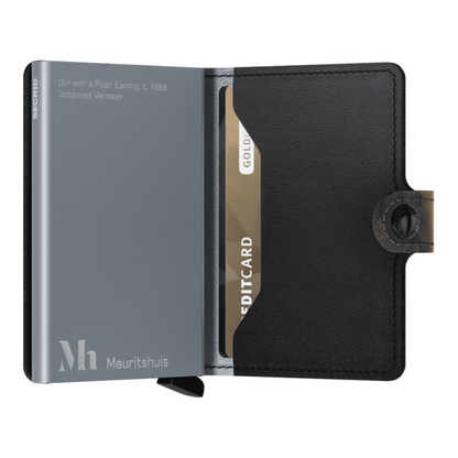 The wallet sits open with metal card protector on the left, with information about the painting while the right has an insert for cards.