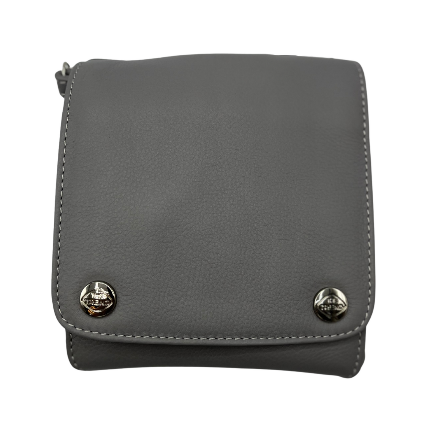 The front of a dark grey leather bag, with a square face and two shiny silver metal buttons, each bearing "The Trend" logo.