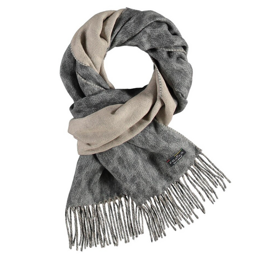A grey scarf is tied, showing two tones of the fabric, one is a light beige while the other is a grey leopard print. Grey tassels line the end of the scarf.