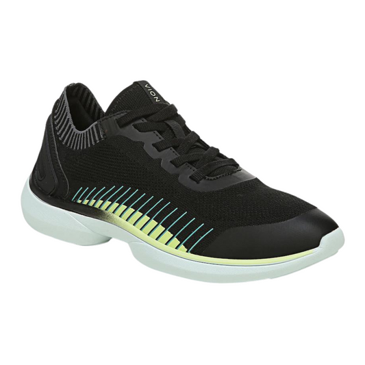 A right angle view of a black sneaker with lime coloured details and a white sole.